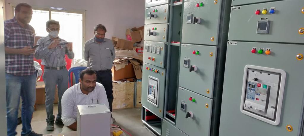 Engineers testing a panel during commissioning